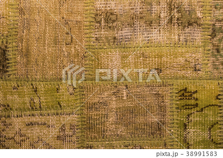 Background of an old worn carpet sewn with thick t 38991583