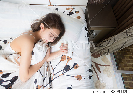 Young asia woman sleeping in her bed. Young asia woman sleeping in her bed. 38991899