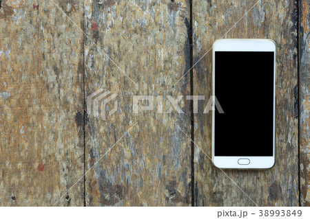 Smartphone on old wood desk on top view. Smartphone on old wood desk on top view. 38993849