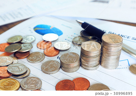 Close up pen and compass and coin stack on income Close up pen and compass and coin stack on income 38996895