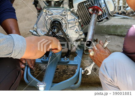 Asian people are repair adapted engine for boat 39001881