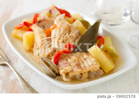 fish stew on white dish on white wooden background fish stew on white dish on white wooden background 39002578