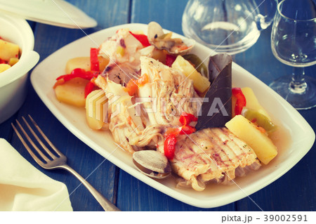 fish stew on white dish with wine 39002591