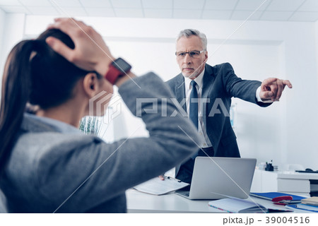 Angry boss outing his young office worker Angry boss outing his young office worker 39004516