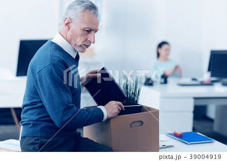 Unhappy adult employee leaving his work 39004919