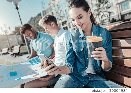 Happy young woman having coffee 39004984