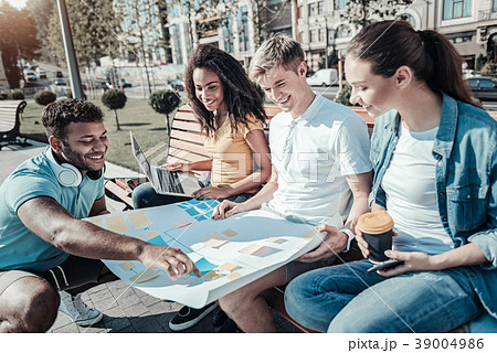 Positive joyful students discussing their project 39004986