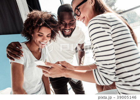 Happy smart woman showing her smartphone Happy smart woman showing her smartphone 39005146
