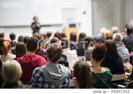 Woman giving presentation in lecture hall at Woman giving presentation in lecture hall at 39007302