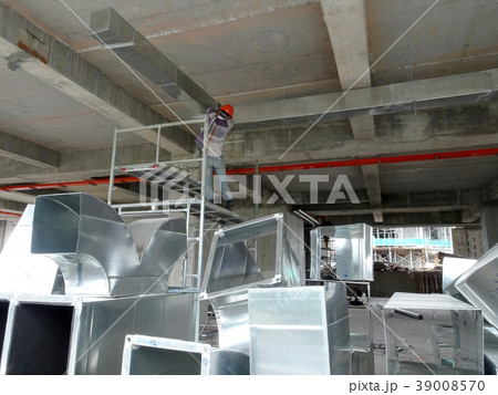 Workers installing air conditioning duct  39008570