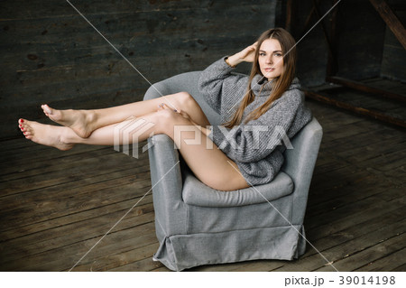 Cheerful woman in long grey knitted cozy sweater Cheerful woman in long grey knitted cozy sweater 39014198