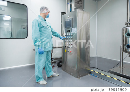Pharmaceutical factory man worker in protective Pharmaceutical factory man worker in protective 39015909