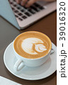 Hot art latte coffee cup on wooden table 39016320