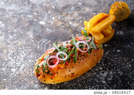 Big hot dog with greens, onion and jalapeno pepper Big hot dog with greens, onion and jalapeno pepper 39018417
