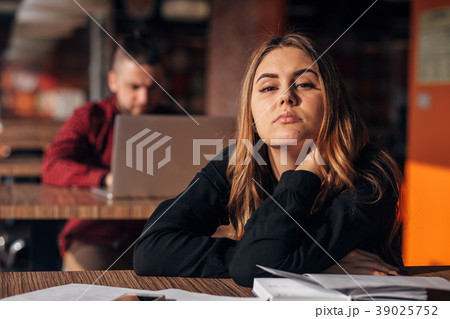 tired businesswoman looks sadly in camera in the 39025752