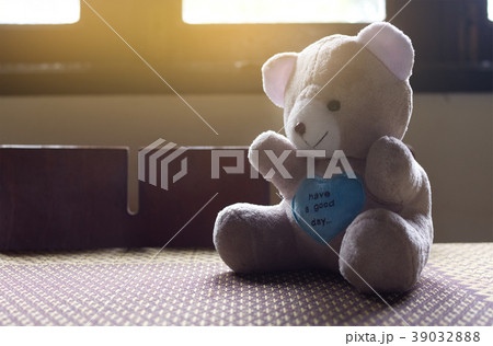 Alone teddy bear sitting on table, Sad concept. Alone teddy bear sitting on table, Sad concept. 39032888