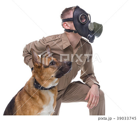 Dog handler in gas mask with shepherd dog Dog handler in gas mask with shepherd dog 39033745