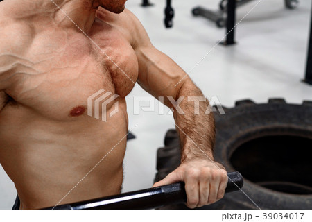 Man with a sledge hammer and tyre. Fitness Man with a sledge hammer and tyre. Fitness 39034017