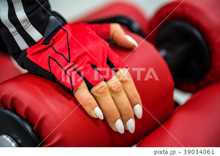 Woman's hand touches gym machine Woman's hand touches gym machine 39034061
