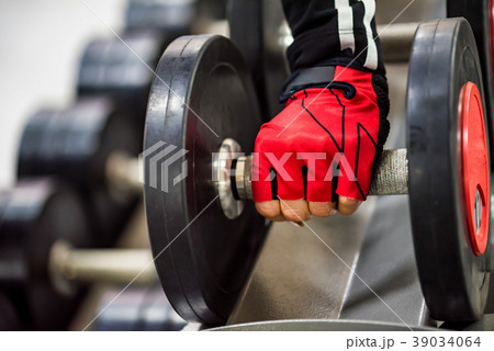 Woman's hand holds dumbbell Woman's hand holds dumbbell 39034064
