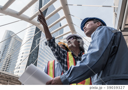 civil engineer and worker at construction site civil engineer and worker at construction site 39039327