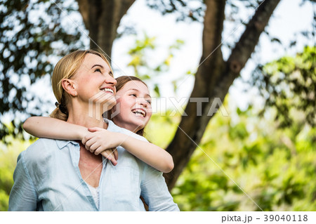 Mother and daughter having fun together in a park. Mother and daughter having fun together in a park. 39040118