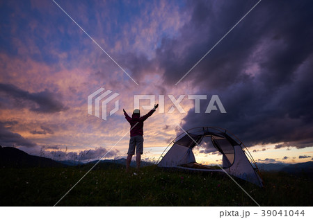 Woman traveller enjoys view on wonderful dawn at mountain 39041044