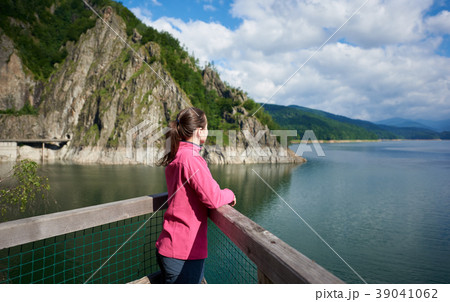 female tourist admiring view of mountains and lake 39041062