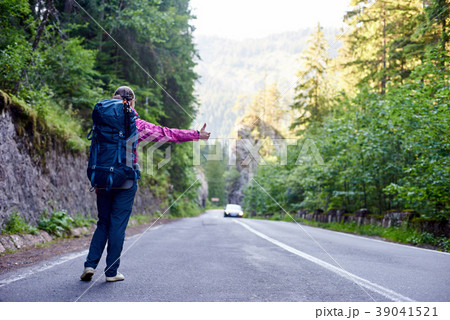 Girl with hitchhiking by the side of the road. Girl with hitchhiking by the side of the road. 39041521