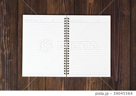 Notebook or empty white paper on wood table Notebook or empty white paper on wood table 39045564