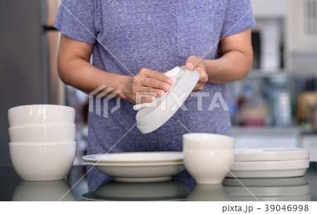 Woman Cleaning product concept wiping dishware  39046998