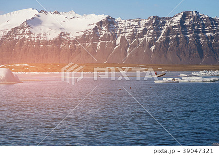 Volcano rock mountain over blue lake Volcano rock mountain over blue lake 39047321