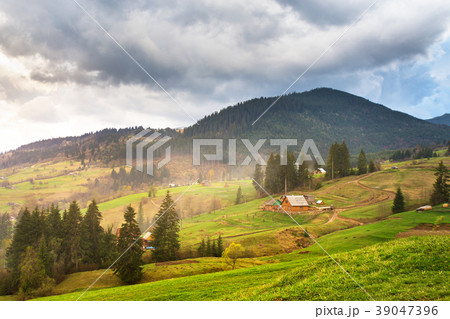 Green spring alpine scene.Mountain village on hill Green spring alpine scene.Mountain village on hill 39047396