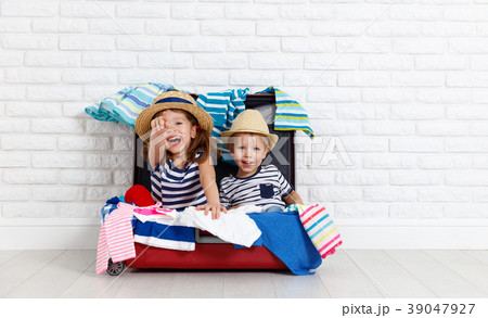 happy laughing children  with suitcase going on a trip 39047927