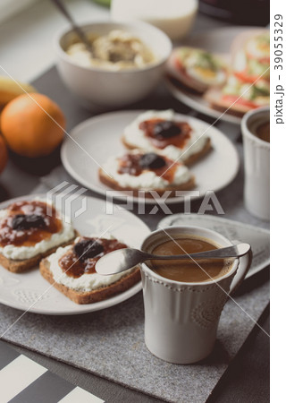 Breakfast with dark coffee and sandwich with jam 39055329
