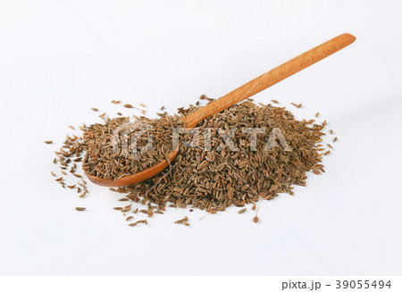 pile and spoon of caraway seeds pile and spoon of caraway seeds 39055494