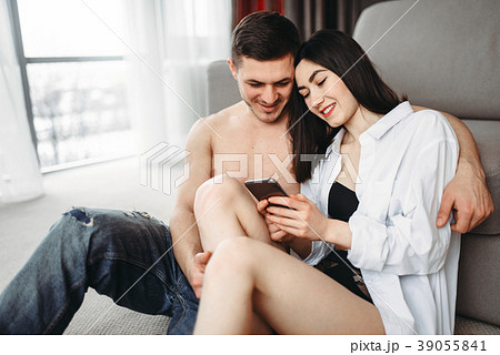 Love couple hugging and look photo on the phone Love couple hugging and look photo on the phone 39055841
