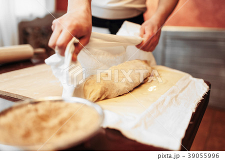 Male chef prepares apple strudel for baking Male chef prepares apple strudel for baking 39055996