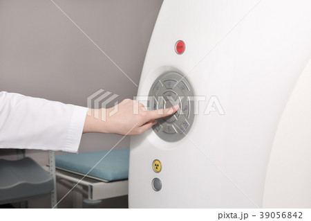 A female doctor pushing control button on CT A female doctor pushing control button on CT 39056842