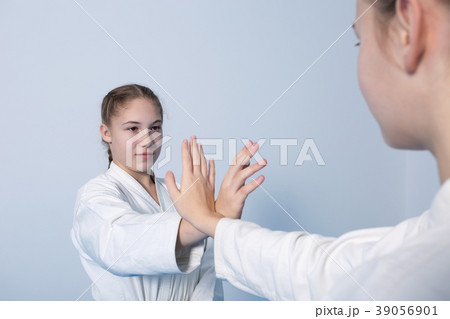 Two girls in black hakama practice Aikido Two girls in black hakama practice Aikido 39056901