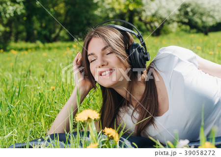 Woman listening music outdoors 39058272