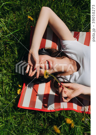 Woman listening music outdoors Woman listening music outdoors 39058273