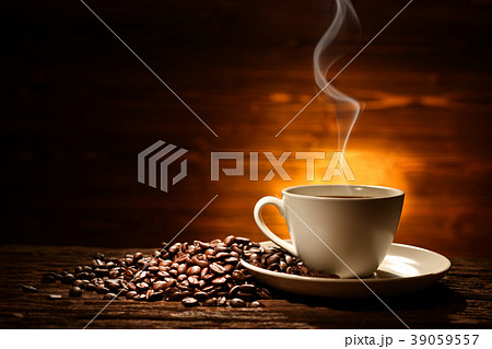 Cup of coffee with smoke and coffee beans 39059557