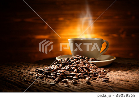 Cup of coffee with smoke and coffee beans Cup of coffee with smoke and coffee beans 39059558