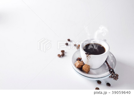 cup of black coffee on a saucer with brown sugar cup of black coffee on a saucer with brown sugar 39059640