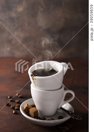 cup of black coffee on a saucer with brown sugar cup of black coffee on a saucer with brown sugar 39059659