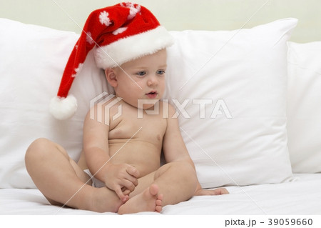 Picture of cute baby wearing santa hat while lying Picture of cute baby wearing santa hat while lying 39059660