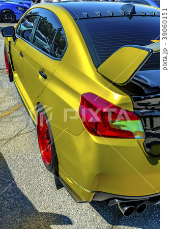 Metallic yellow car with large spoiler red rims 39060151