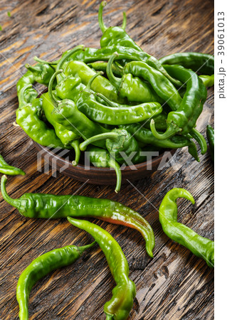 green chili peppers placed in a clay plate o 39061013