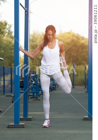 Slim brunette woman exercising in outdoor gym 39061211